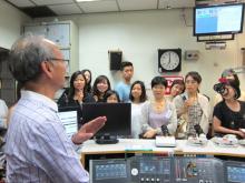 Mr TAI is introducing the operations of different studios in RTHK.